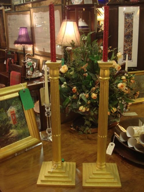 lovely pair of tall and imposing corinthian column gilt wood candlesticks